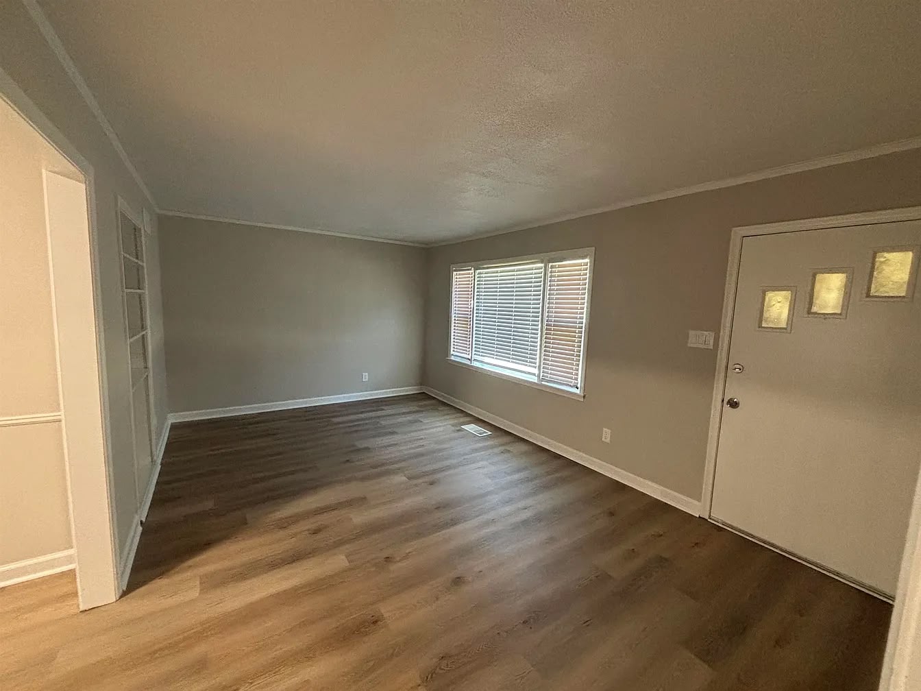 Living room with wood flooring and front door at 2805 W Lake Shore Dr