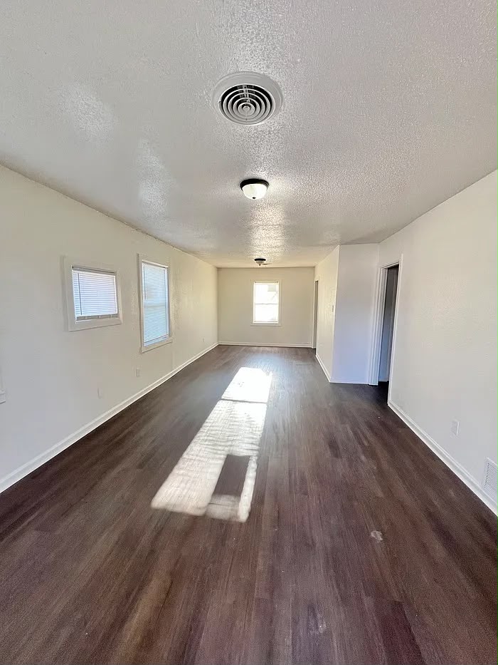 Open living room with dark wood flooring at 801 Dawn Cove