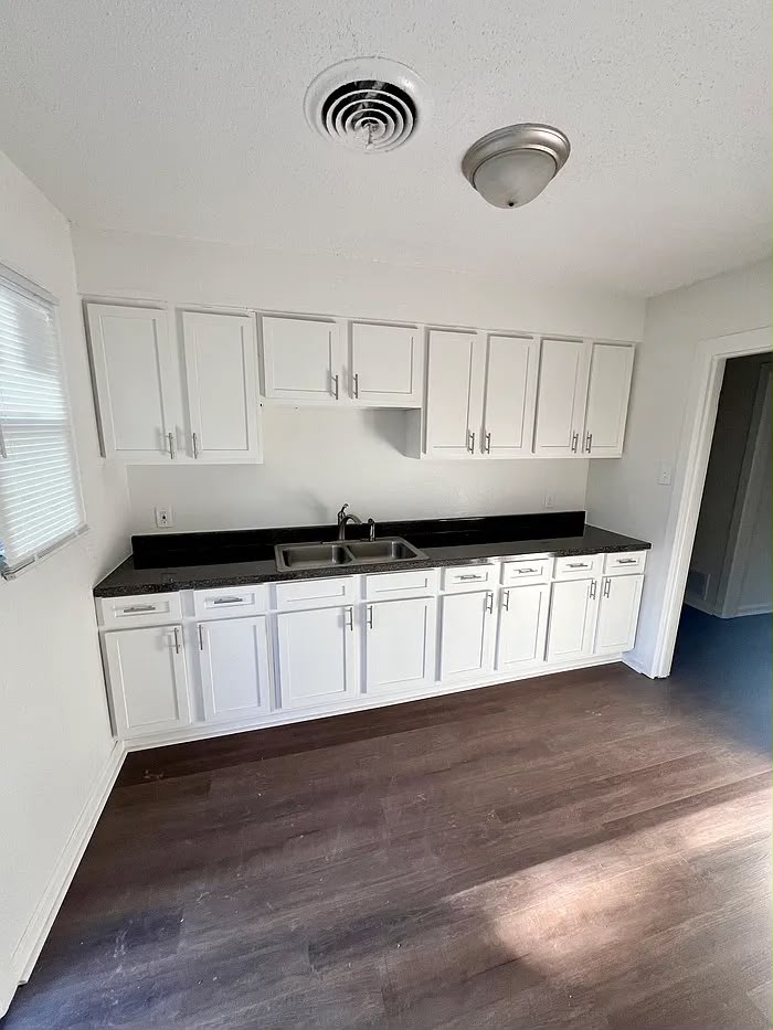 White kitchen with dark countertops at 801 Dawn Cove