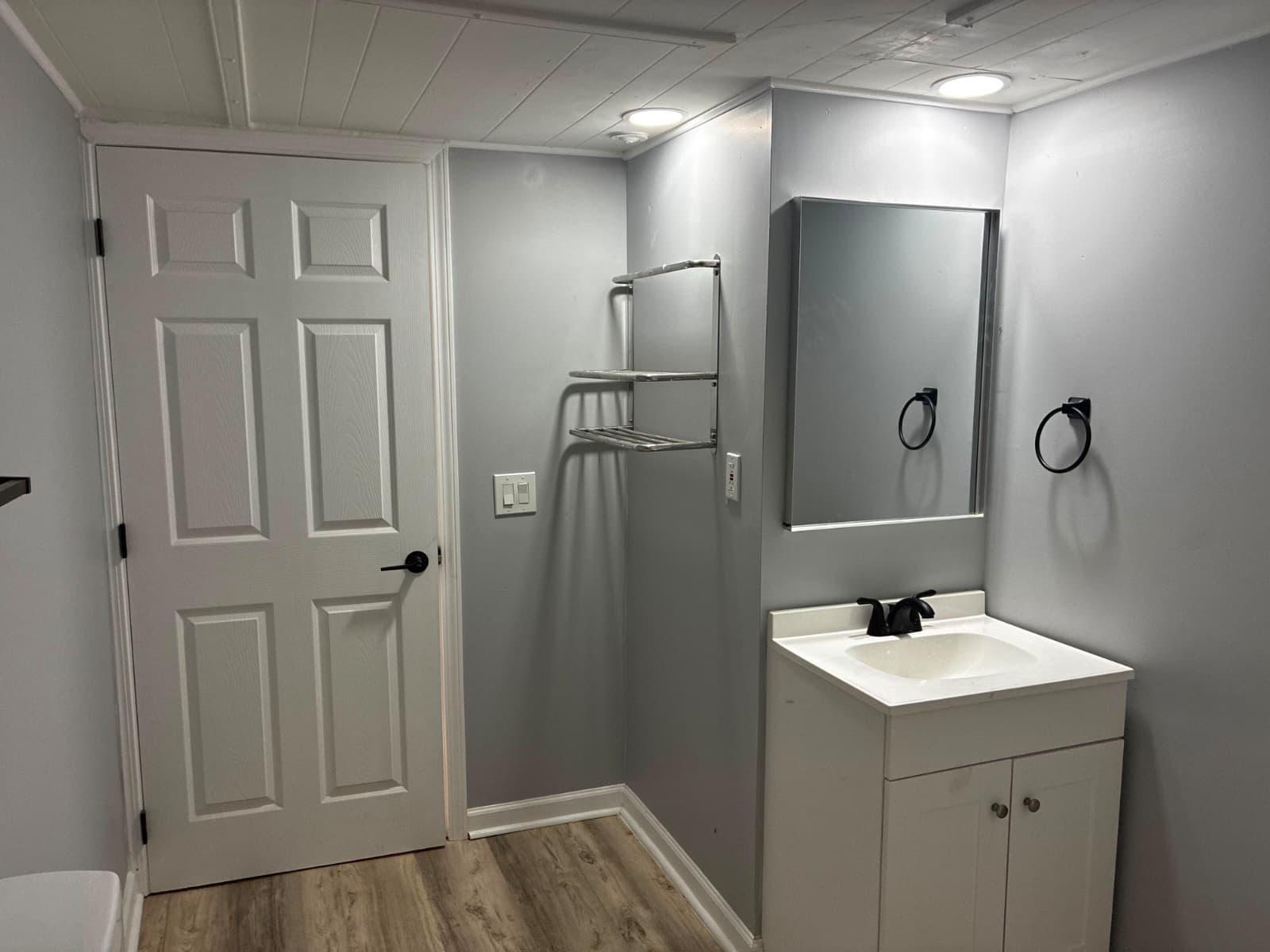 Second bathroom with vanity and mirror at 151 Fleetwood Dr