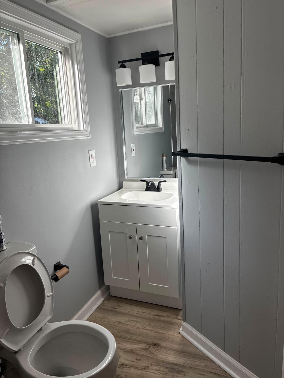 Bathroom with white vanity and window at 151 Fleetwood Dr