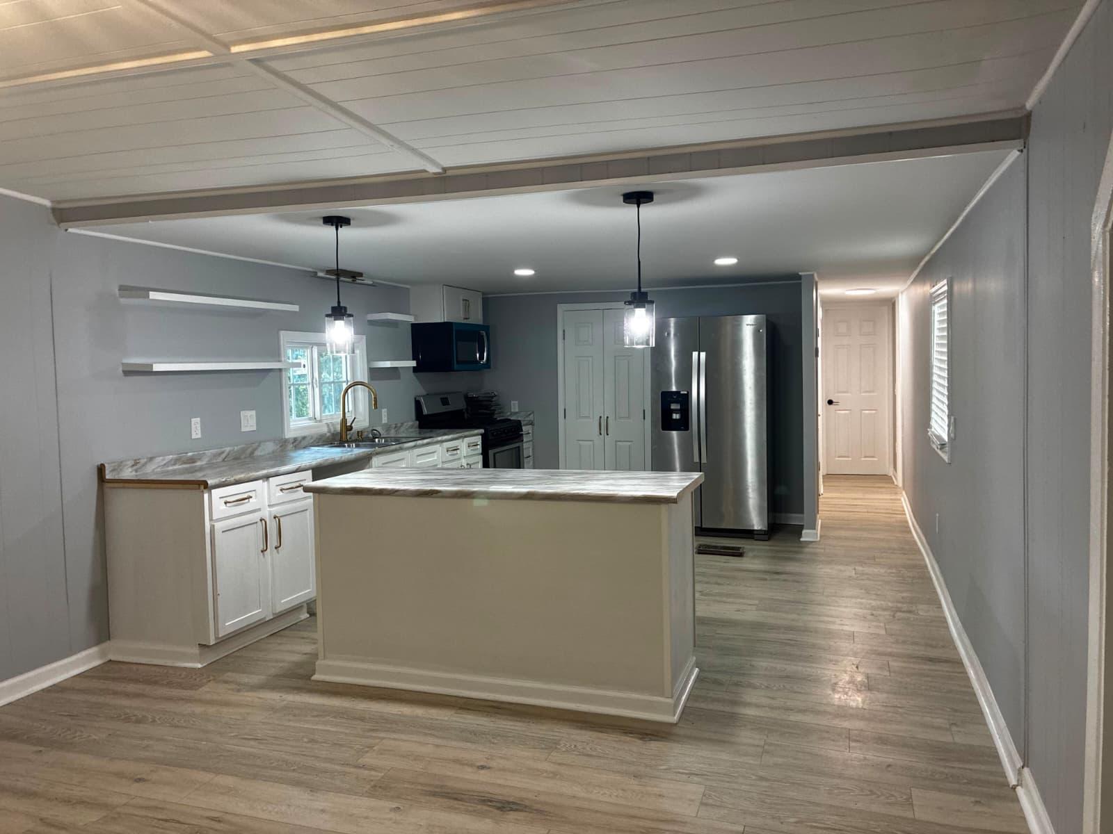 Open kitchen and island looking down the hallway at 151 Fleetwood Dr