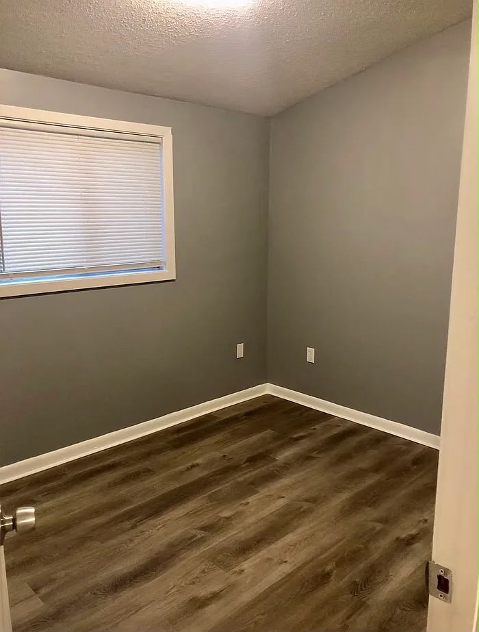 Bedroom with window blinds and wood-look flooring at 2805 W Lake Shore Dr