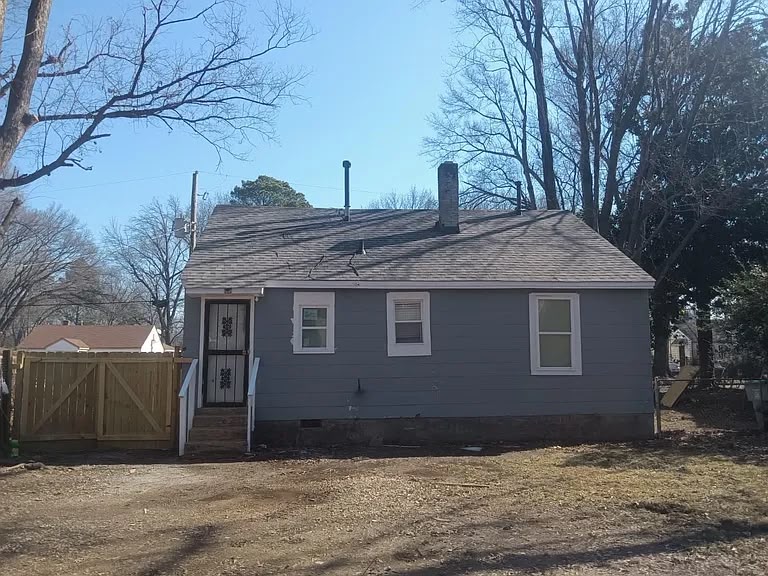 Rear exterior of 1443 Wrenwood St with fenced yard
